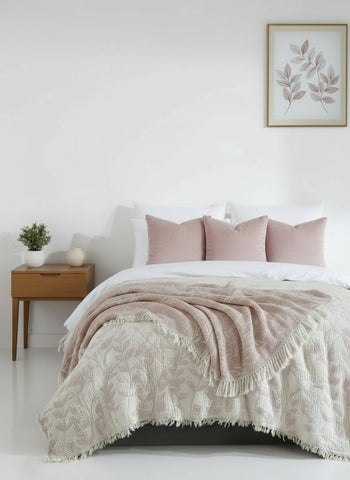 Bedroom with a bed covered in a textured comforter, nightstand, and wall art.