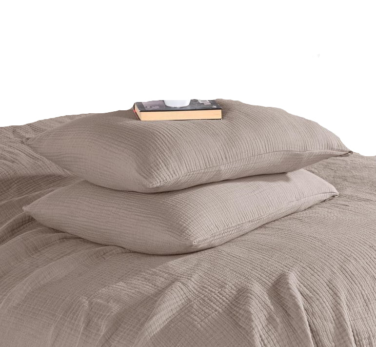 Gray textured bedding set with a mug and book on a bed