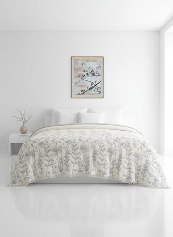 Bedroom with floral comforter, striped curtains, and framed artwork.